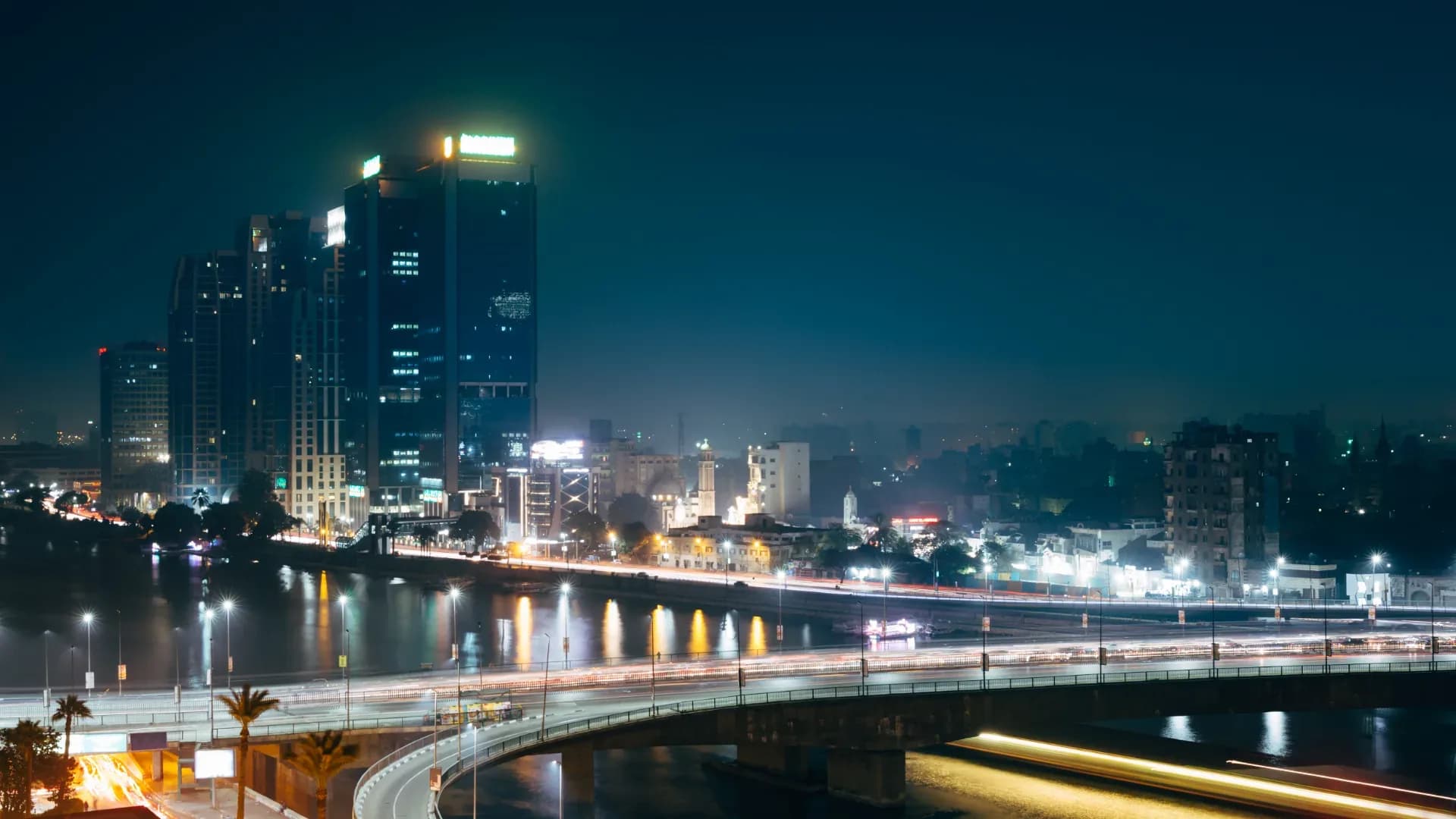 Office towers and a bridge over the Nile in Cairo at night