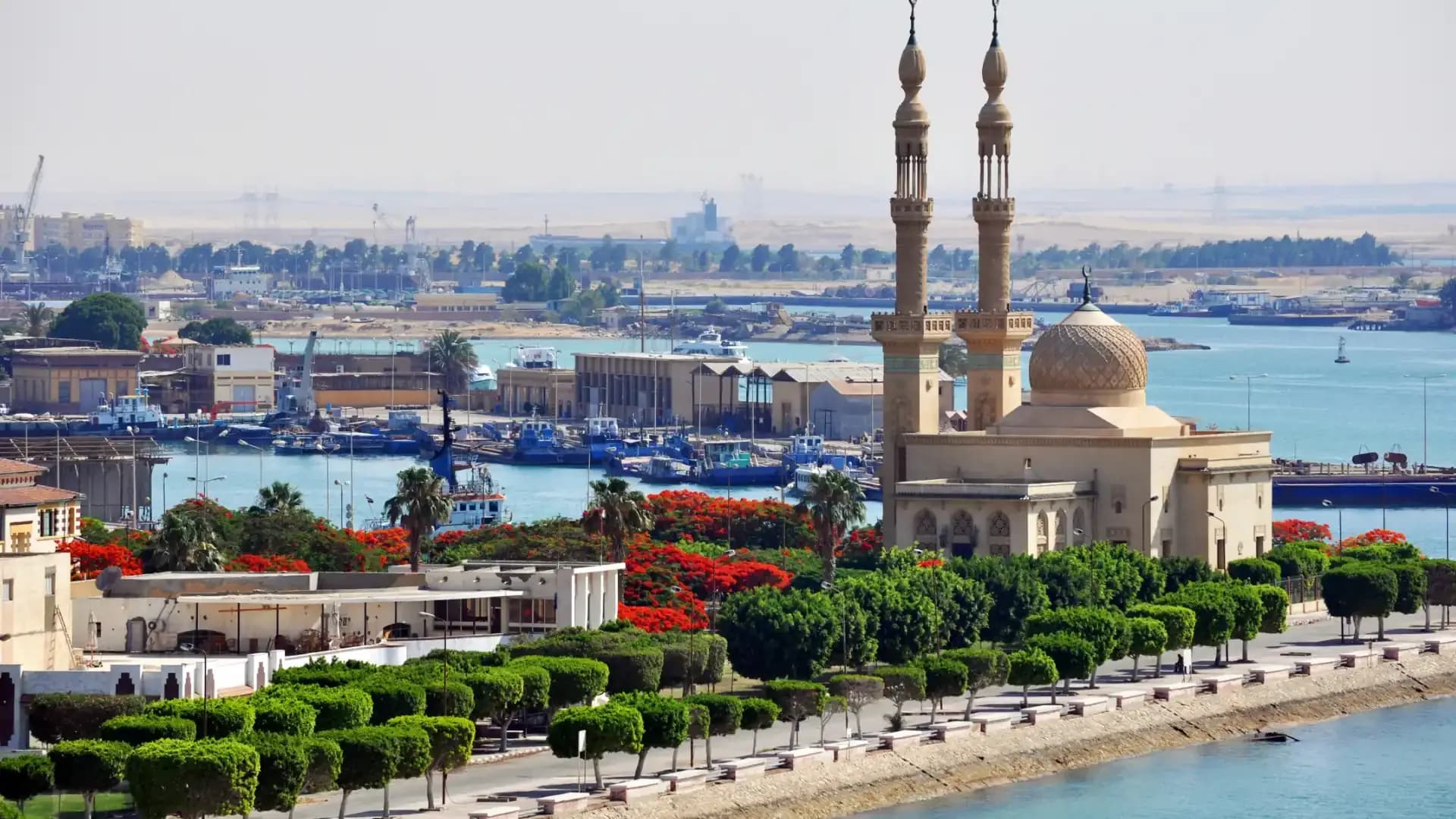Port Tawfik on the Suez Canal, with its mosque, flame trees and harbour