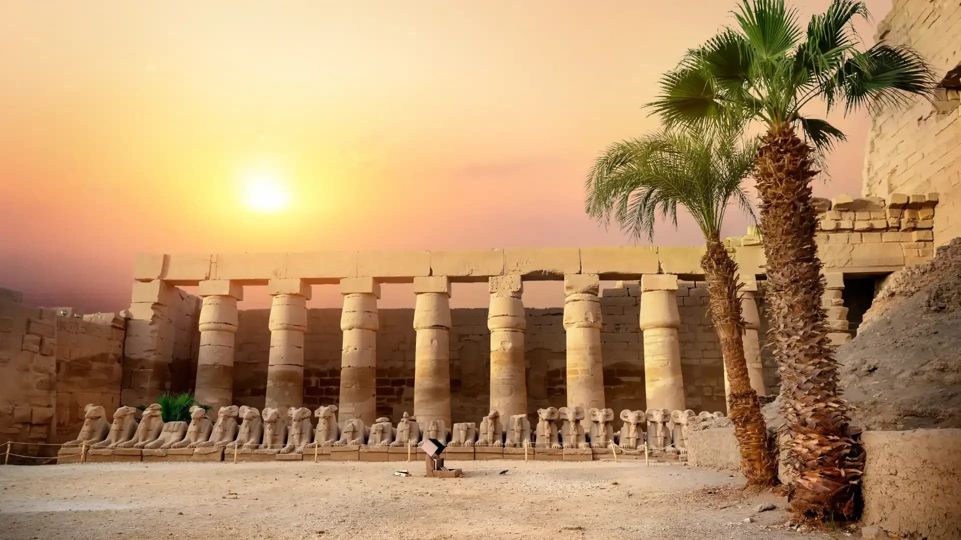 The avenue of ram-headed sphinxes and the colonnade at Karnak Temple, Luxor, at sunset