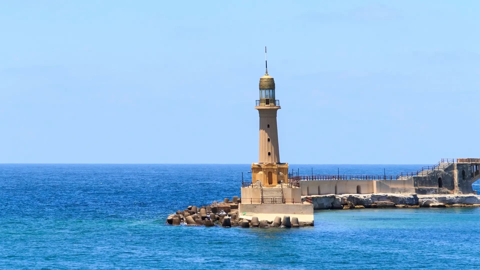 The lighthouse on the breakwater of Alexandria's harbour above a deep blue Mediterranean